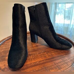 Black boots with shimmery lace type detail.